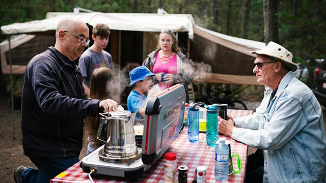 Family at campsite picnic table