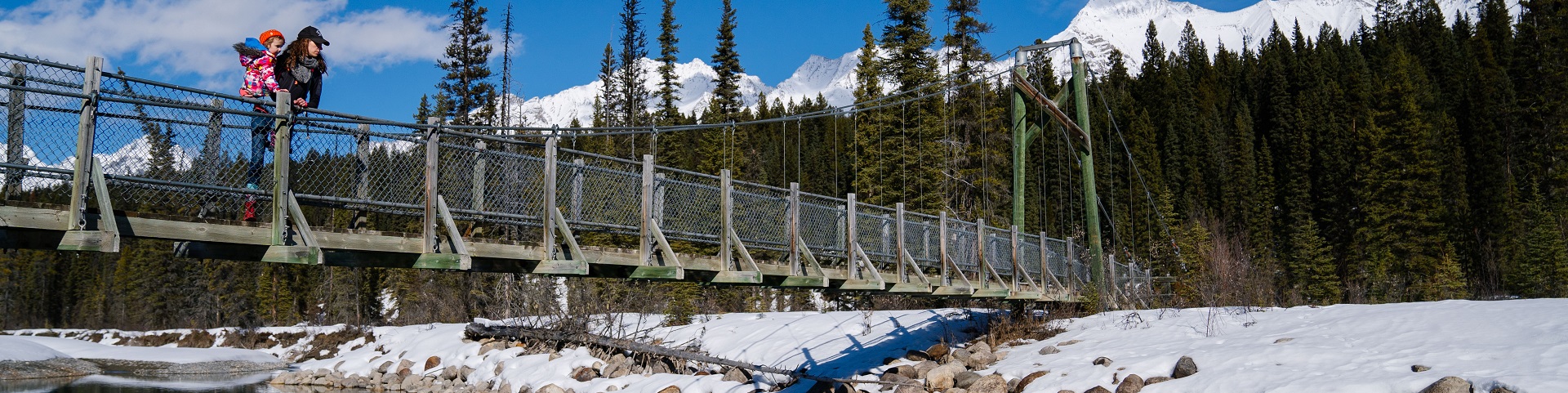 visitor and child enjoying the view from a bridge