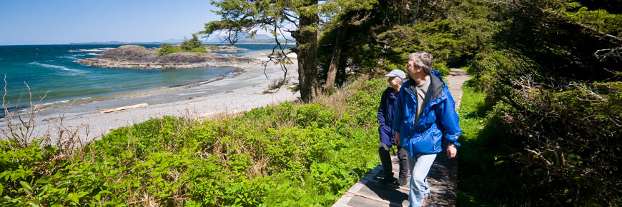 A couple hiking along the shoreline on a boardwalk