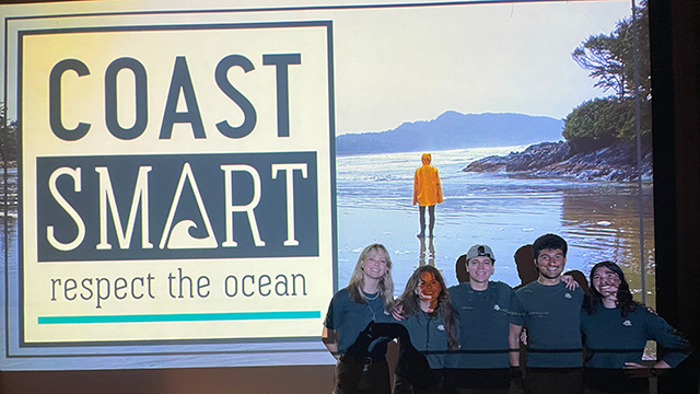 a group of people in front of a screen