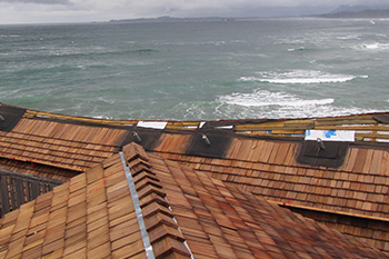 The new shake roof on the visitor centre with Wickaninnish Beach in the background.