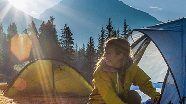 a camper setting up their tent