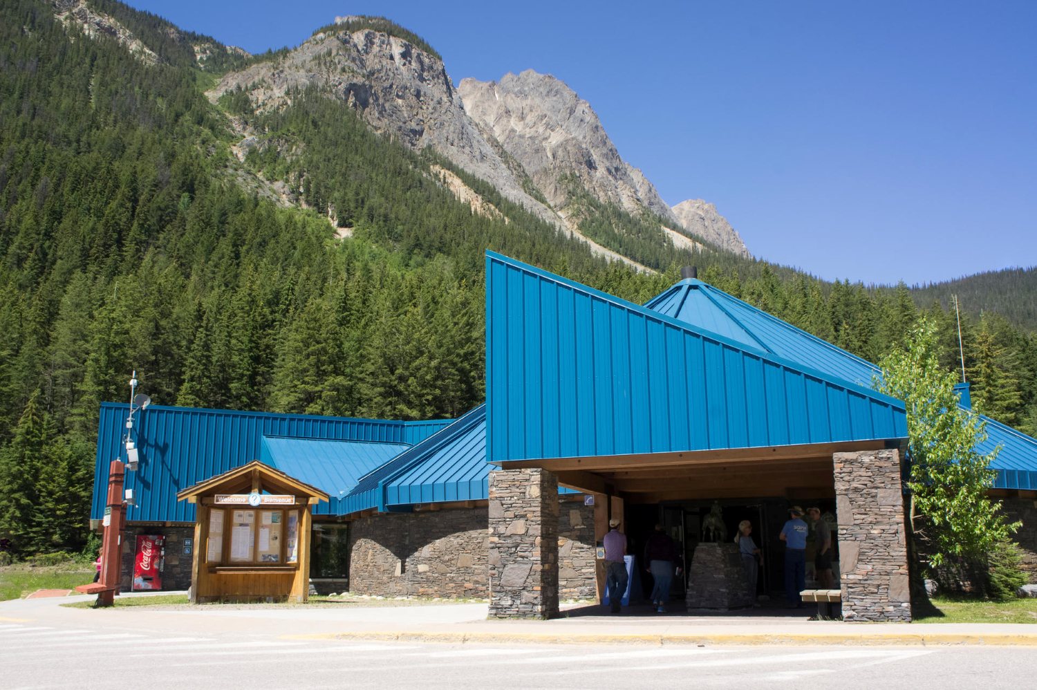 Yoho Visitor Centre, a stone building capped with a steep-angled, blue metal roof