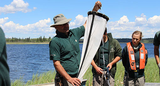 Christian Tremblay, demonstrating the substrate sampler, one of 3 ways to test park waters for zebra mussels. 