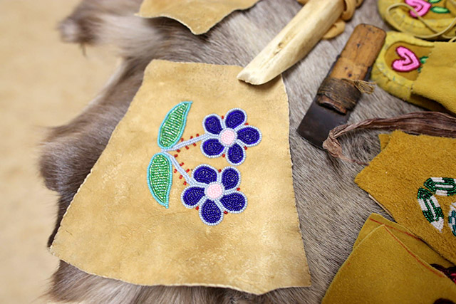 A close-up of beadwork on caribou fur.