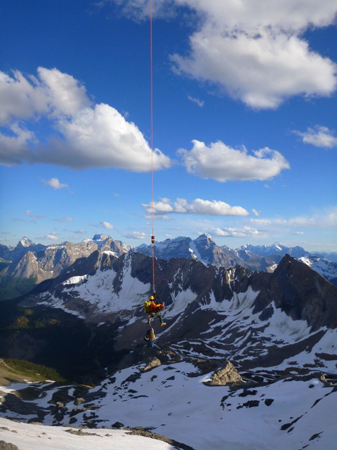 A Parks Canada Visitor Safety Specialist heli-slings the injured subject to the staging area.