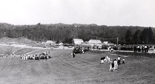 People gathering in a field.