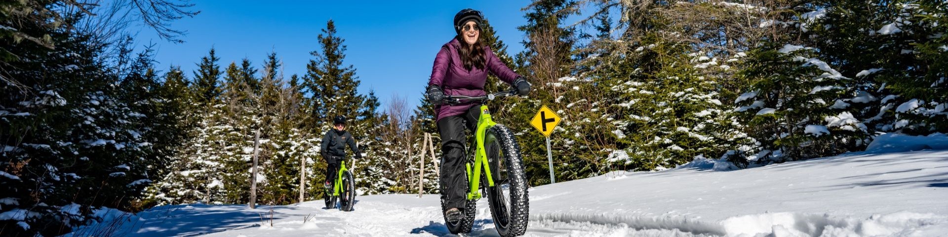 A visitor rides a groomed trail on her fatbike. 
