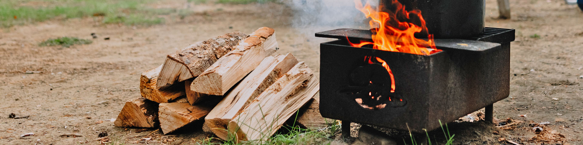 A pile of wood near a fire pit