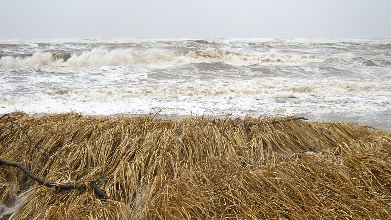 Big waves crashing against the shore during a storm.