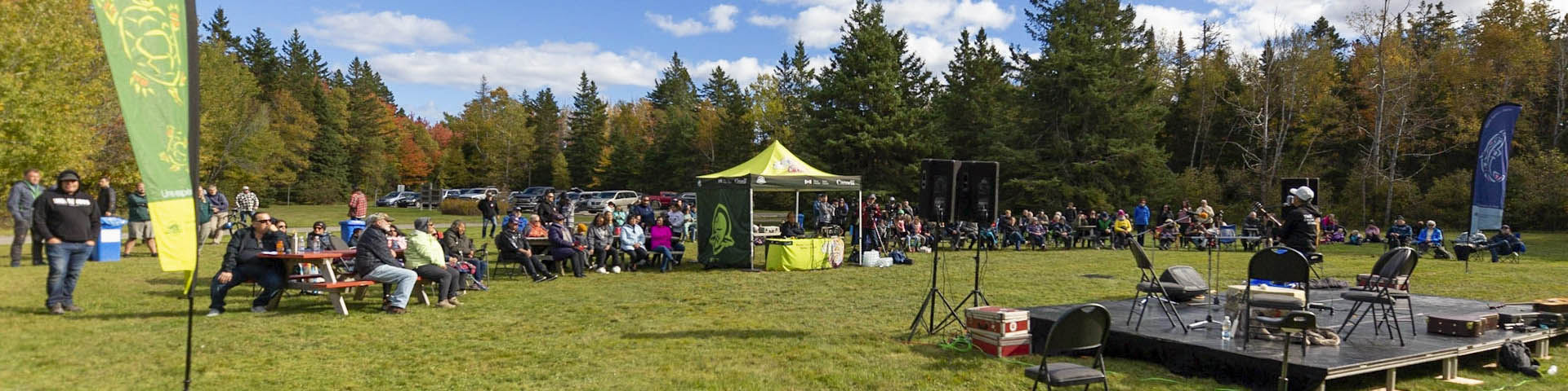 A musician performs in front of a crowd at La Source in Kouchibouguac National Park