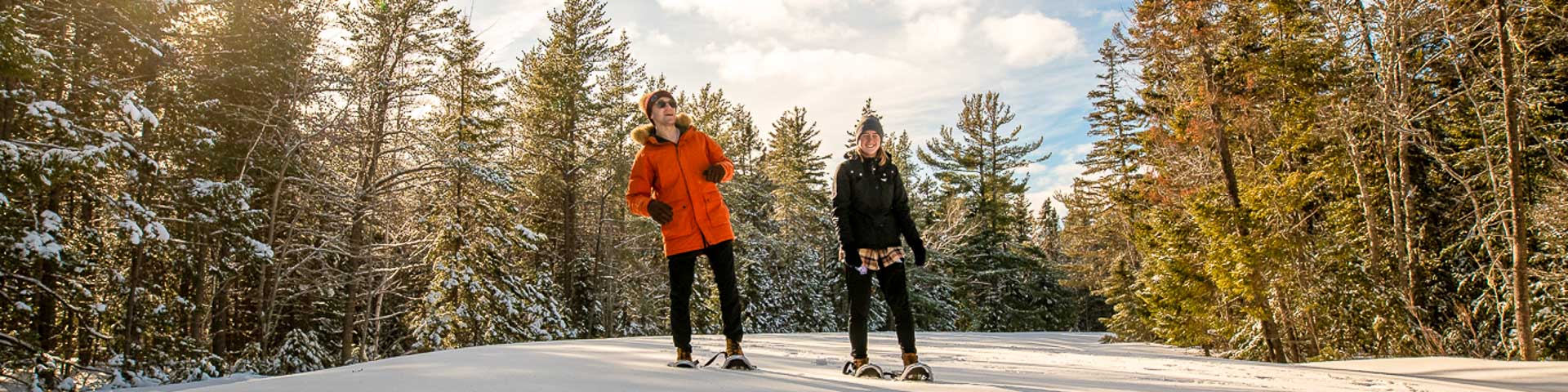 A couple snowshoeing in the forest