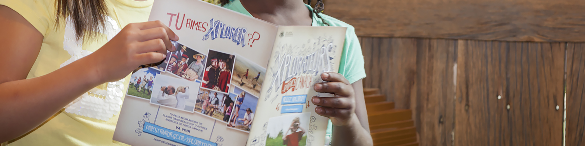 Kids holding a Parks Canada Xplorers booklet.