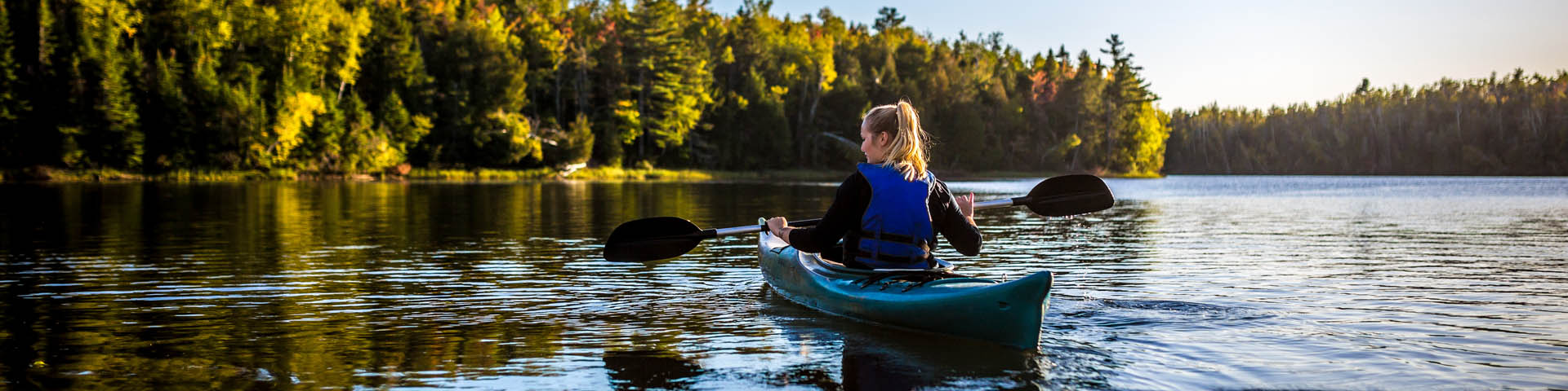 A kayaker on the river in the fall.