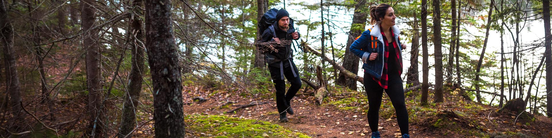 Two people hiking near a river