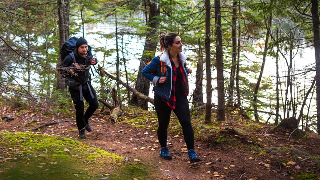 Two people hiking near a river