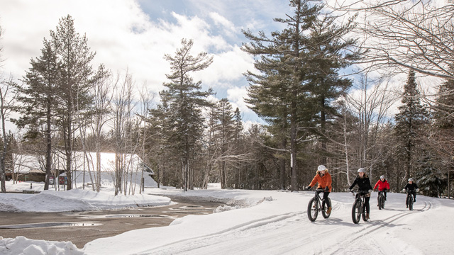 Cyclists on the snow near the Visitor Reception Centre
