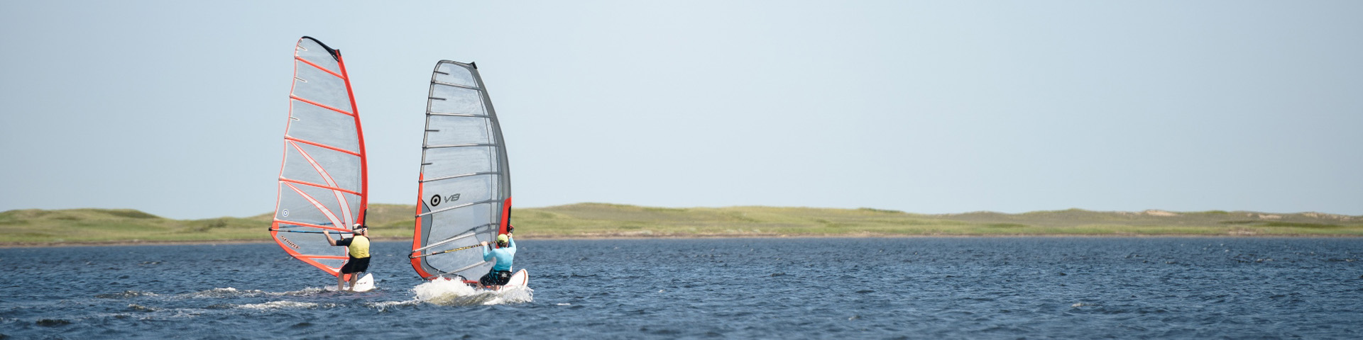 Two visitors windsurfing near Callanders beach.