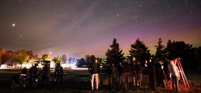 A group of people observing the sky