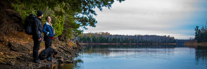 A couple and their dog on a riverbed