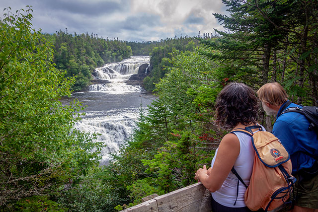 Two people overlooking Baker's Brook Falls in Gros Morne National Park 