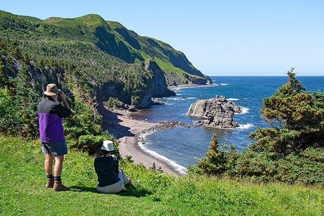 Two people enjoying the view of the water on the Green Gardens trail in Gros Morne National Park