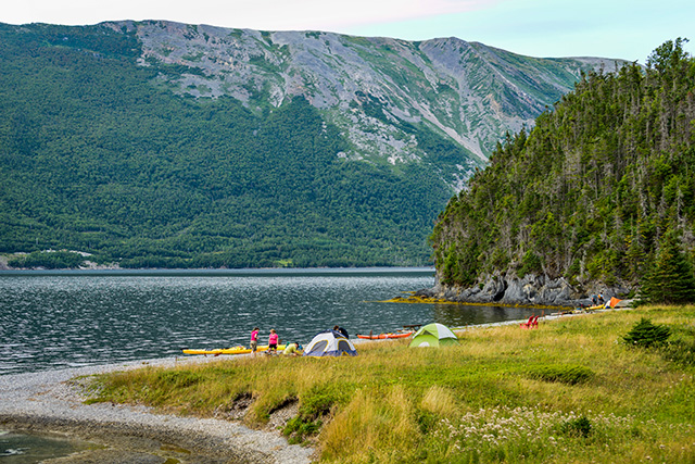 People kayaking and tenting on the beach of Stanleyville in Gros Morne National Park