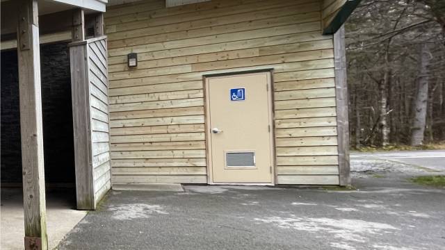 A paved driveway in front of a building with a door.