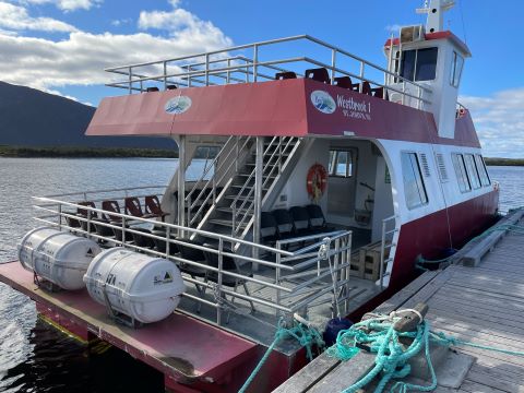 A tour boat tied to a dock.