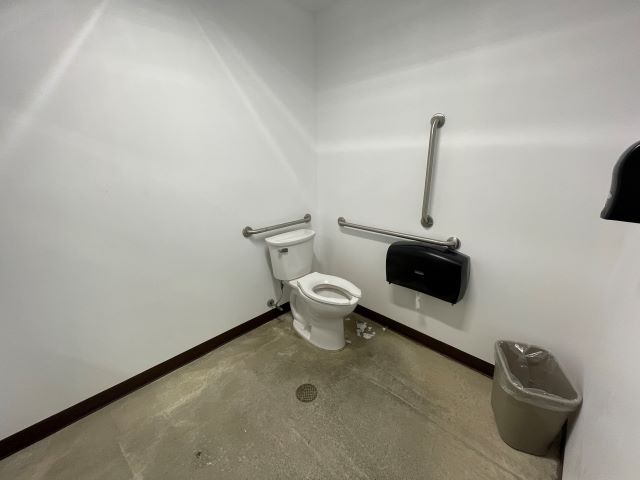 A toilet in a bathroom.