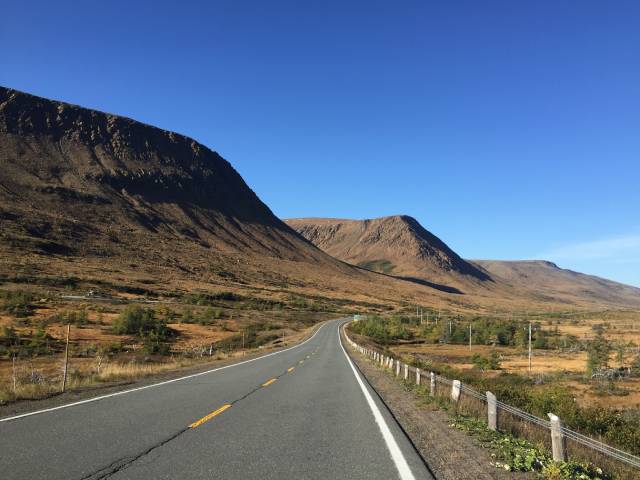 A road with mountains in the background.
