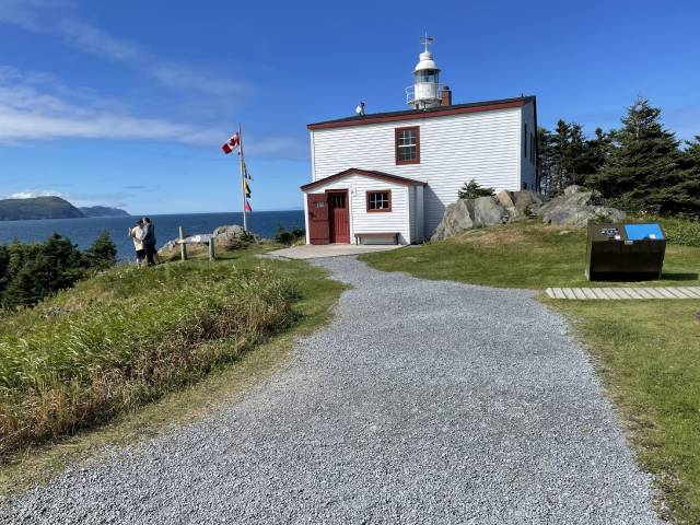 A gravel path leading to a lighthouse.