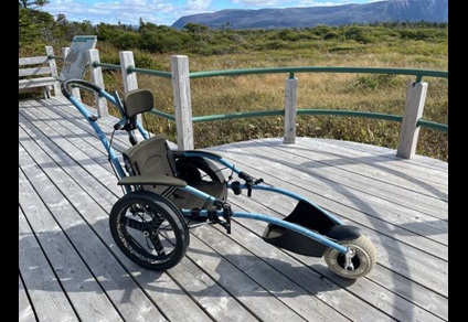 A wheelchair with a ballon tire in front.