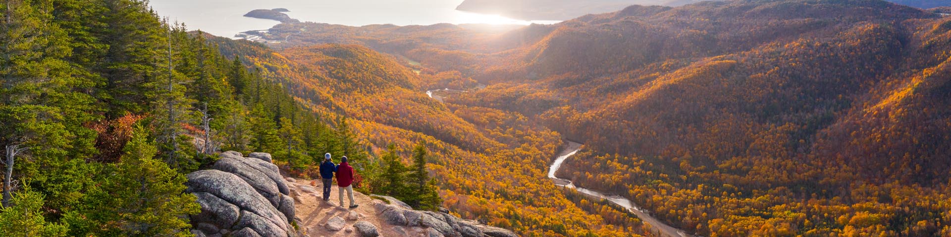 Two people at a viewpoint on a hiking trail.