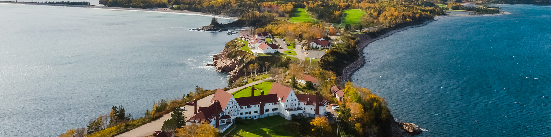 An aerial view of the Keltic Lodge with fall colours in the background.