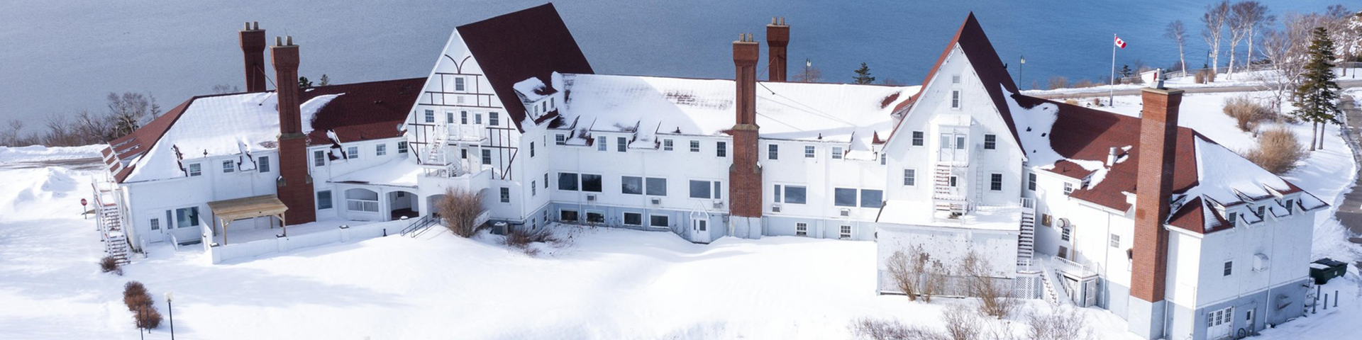 The Keltic Lodge main lodge surrounded by snow covered grounds.