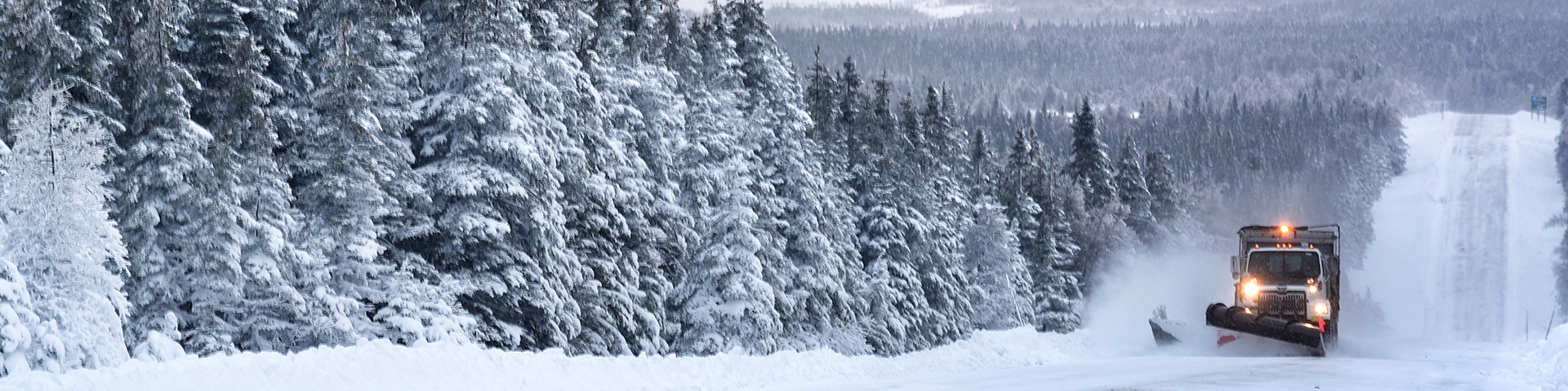 A snowplow clearing a stretch of the Cabot Trail in Cape Breton Highlands National Park.