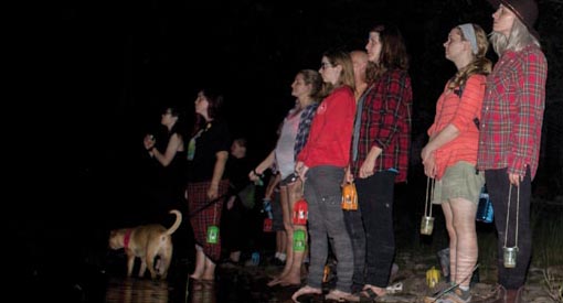 A group of visitors on a night hike.