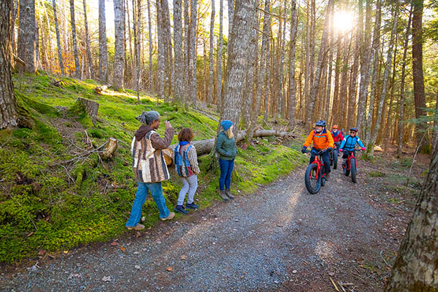 Three hikers meet three cyclists on the trail.