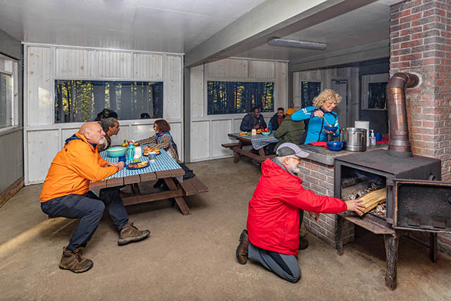 Visitors enjoy the picnic shelter and wood stove in the colder season.