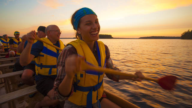 A group of people in a big canoe. 