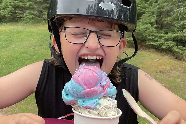 A child eating an ice cream cone.