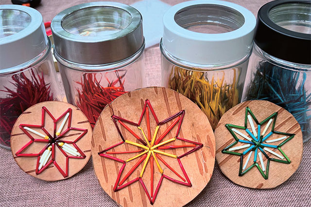 Three quillwork samples and four jars of coloured porcupine quills.