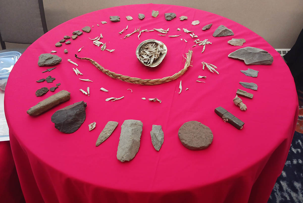 A table of artifacts and a braid of sweet grass. 