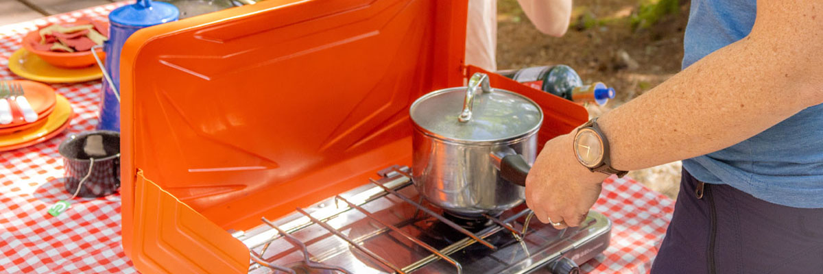 Person cooking on a campstove.