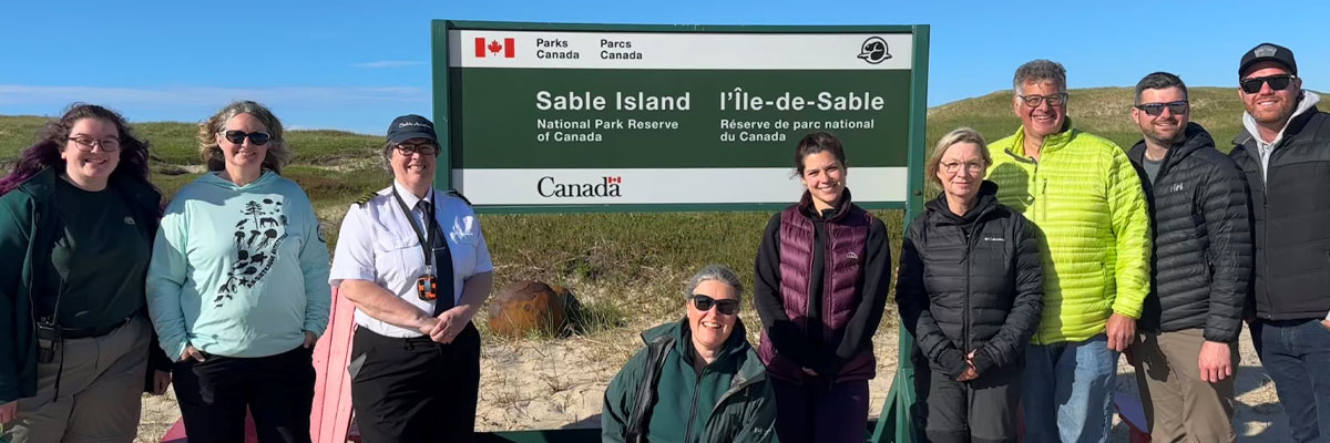 A group of visitors with Sable Aviation pilot and Parks Canada staff.