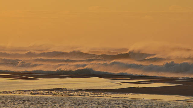 Big surf crashing on the beach from a fall storm.