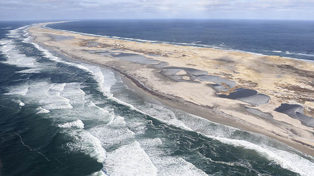 An aerial view of Sable Island surrounded by water.