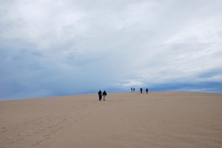 Hikers on sand beach