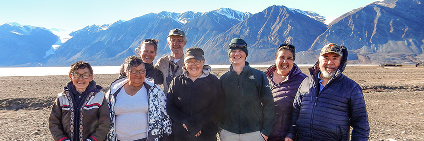 A group of people with mountains in the background
